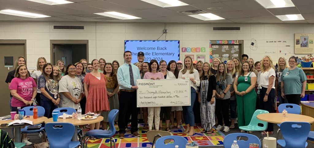 photo of Piedmont Lithium representative presenting a check to group