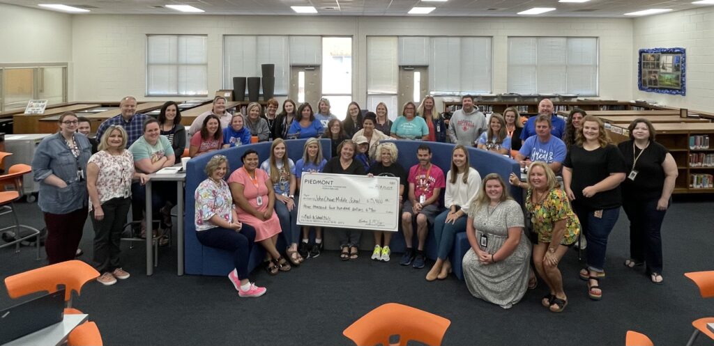 photo of Piedmont Lithium representative presenting a check to group