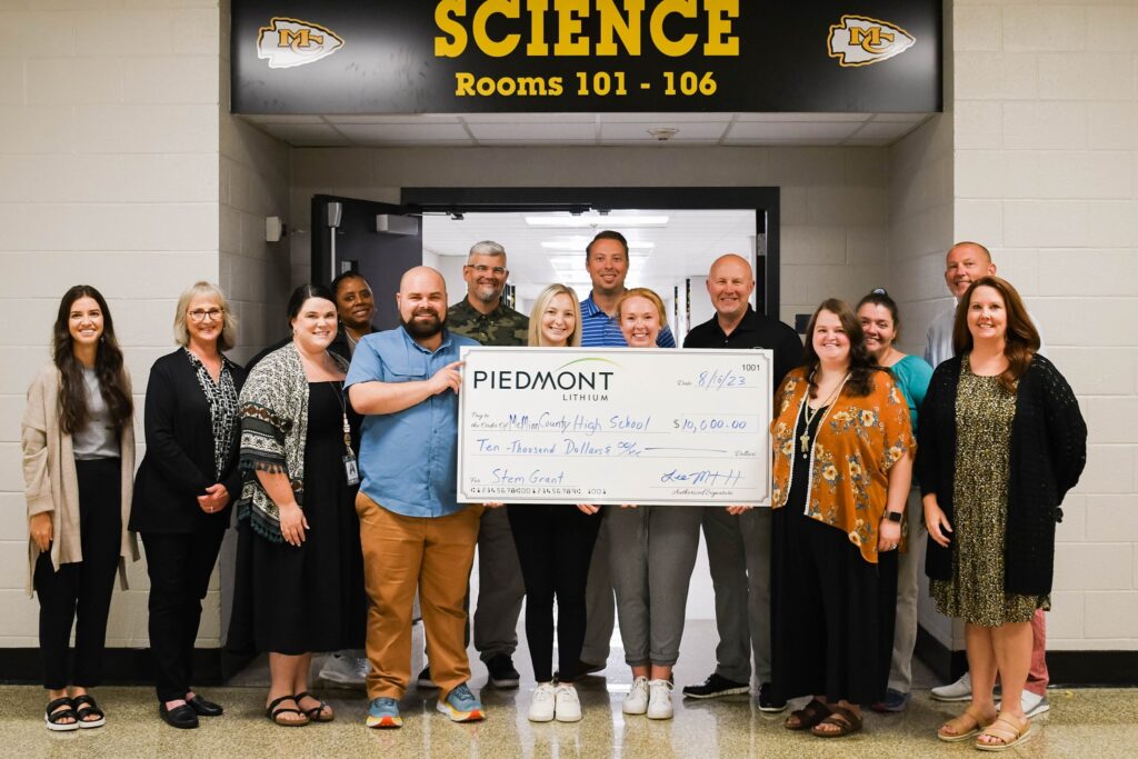 photo of Piedmont Lithium representative presenting a check to group