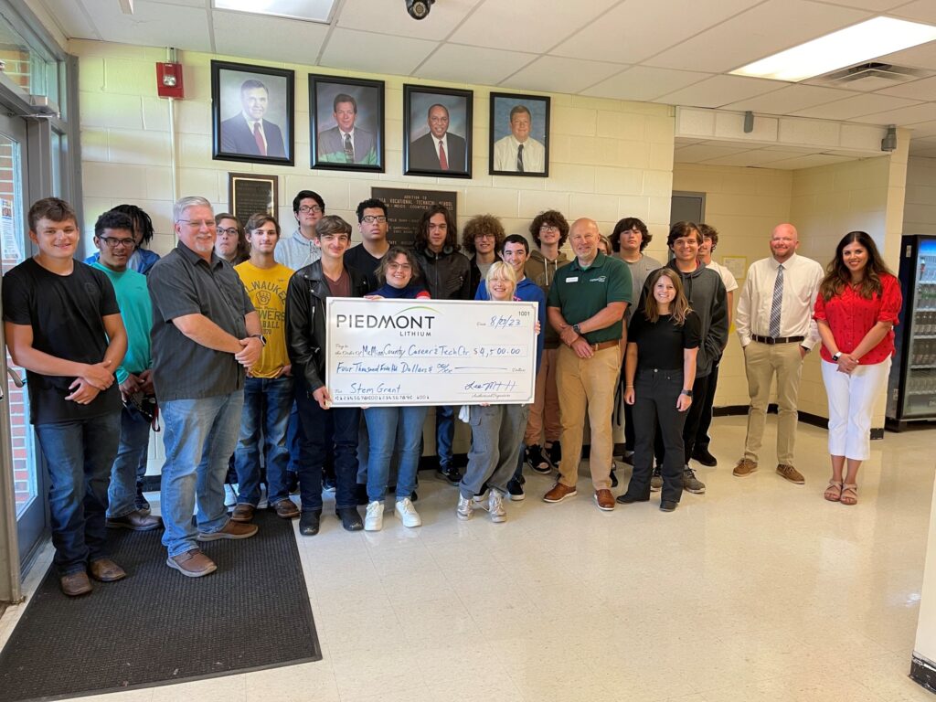 photo of Piedmont Lithium representative presenting a check to group