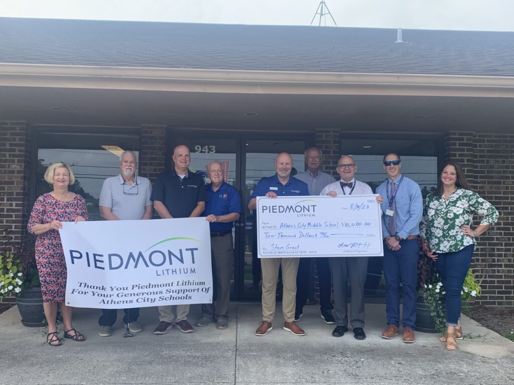 photo of Piedmont Lithium representative presenting a check to group