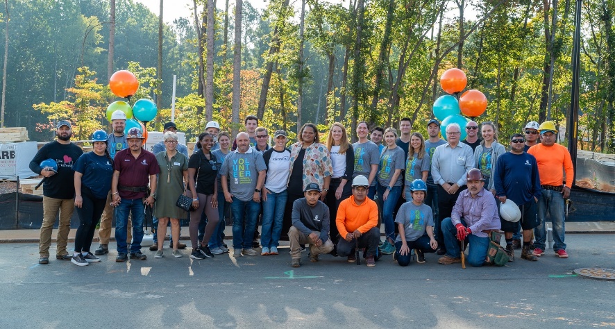 A group photo of Piedmont Lithium employees with Habitat for Humanity staff, and the Habitat for Humanity recipent